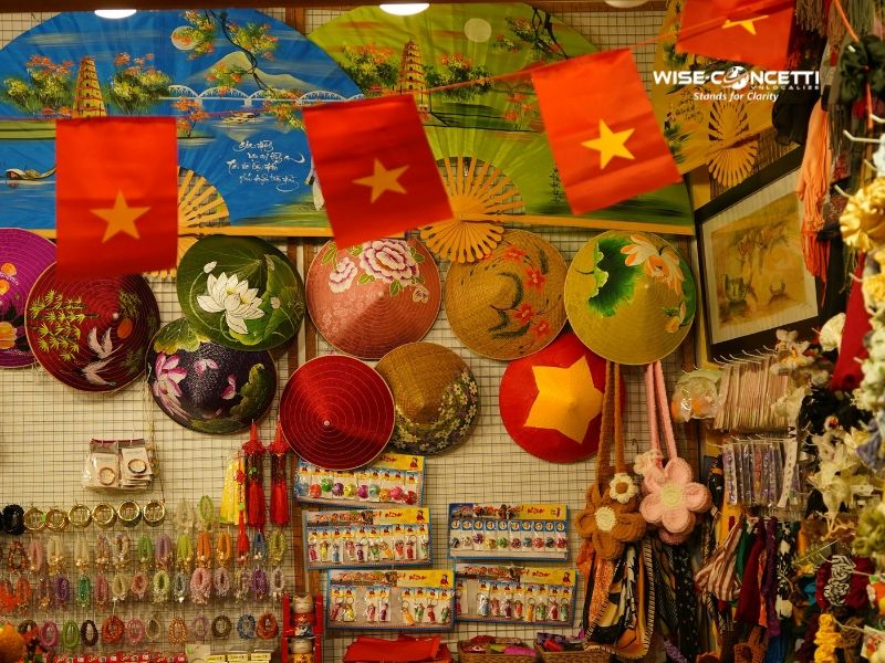 Vietnamese souvenir shop displaying traditional conical hats and national flags tied to local cultural identity